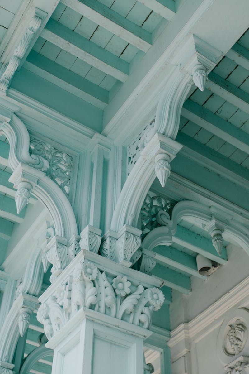 From below of majestic ornamental ceiling and columns of aged classic building in city