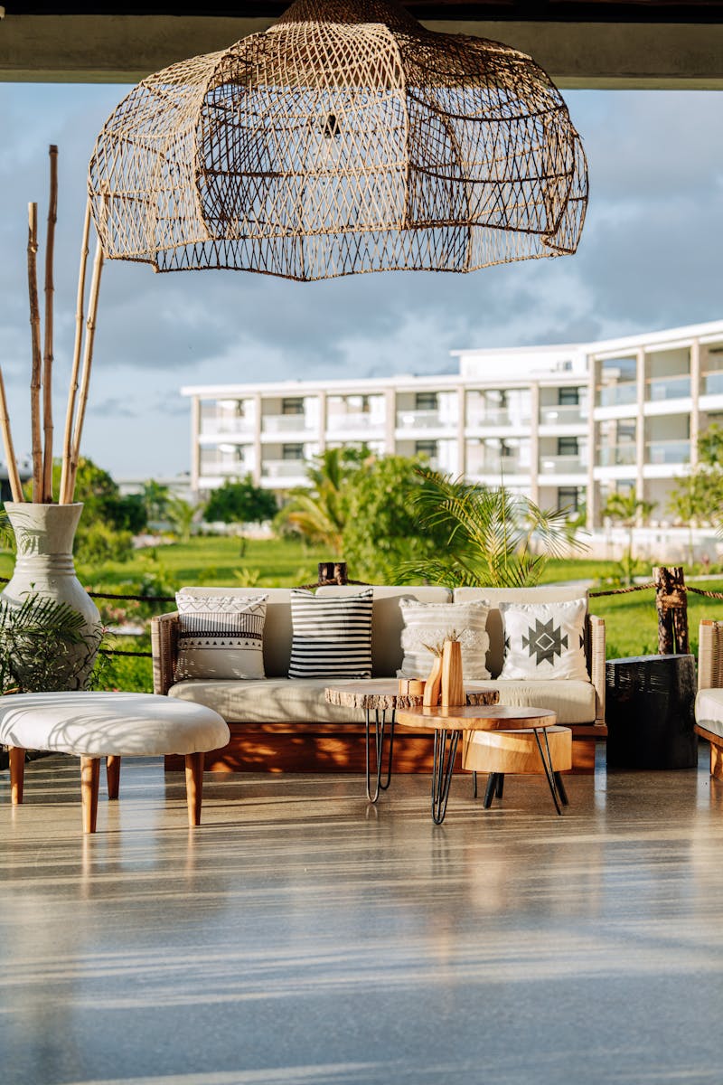 Elegant outdoor terrace in Zanzibar showcasing modern furniture and lush greenery, perfect for relaxation.
