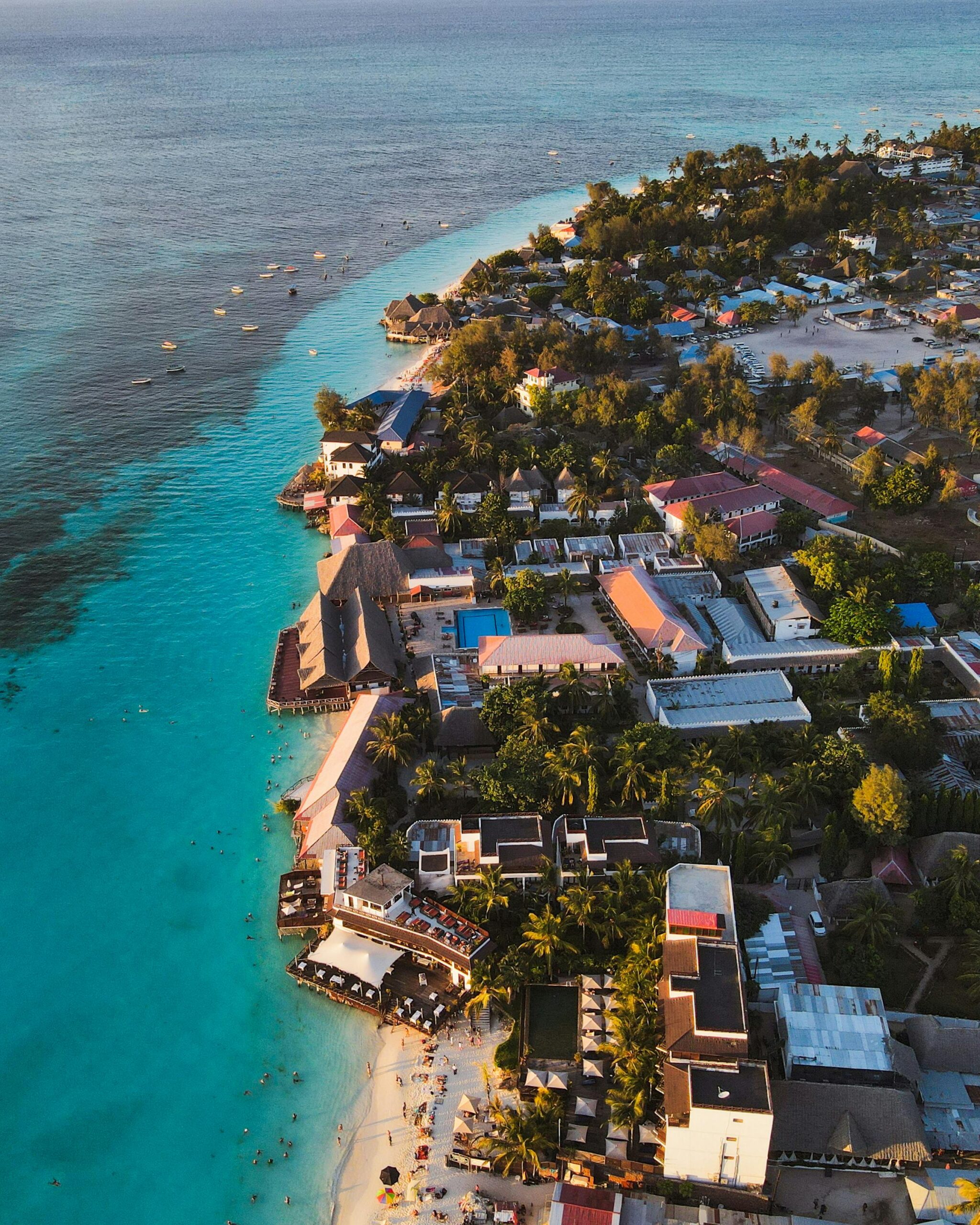 Stunning aerial view of Nungwi beach in Zanzibar showcasing turquoise waters and lush resorts.